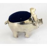 a novelty silver pig pincushion