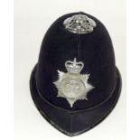 An obsolete Lancashire Constabulary police helmet with badge. Retains its chin strap but no liner
