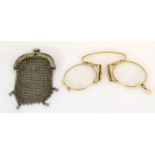 A Pair Of Gold Framed Glasses And A Misers Purse