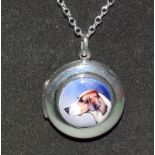 A Silver Locket With Enamel Image Of A Dog