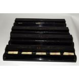 A set of four lacquered Mah Jong tile racks 42cms long and fifty three bone counter sticks