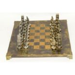 A Cast Metal Chess Set With Matching Board