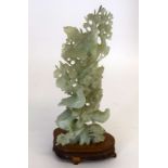 Large Chinese carved green (poss jade) group of birds set on a carved and fitted wooden base. 35cm