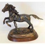 A Bronzed Figure Of A Horse On Wooden Base