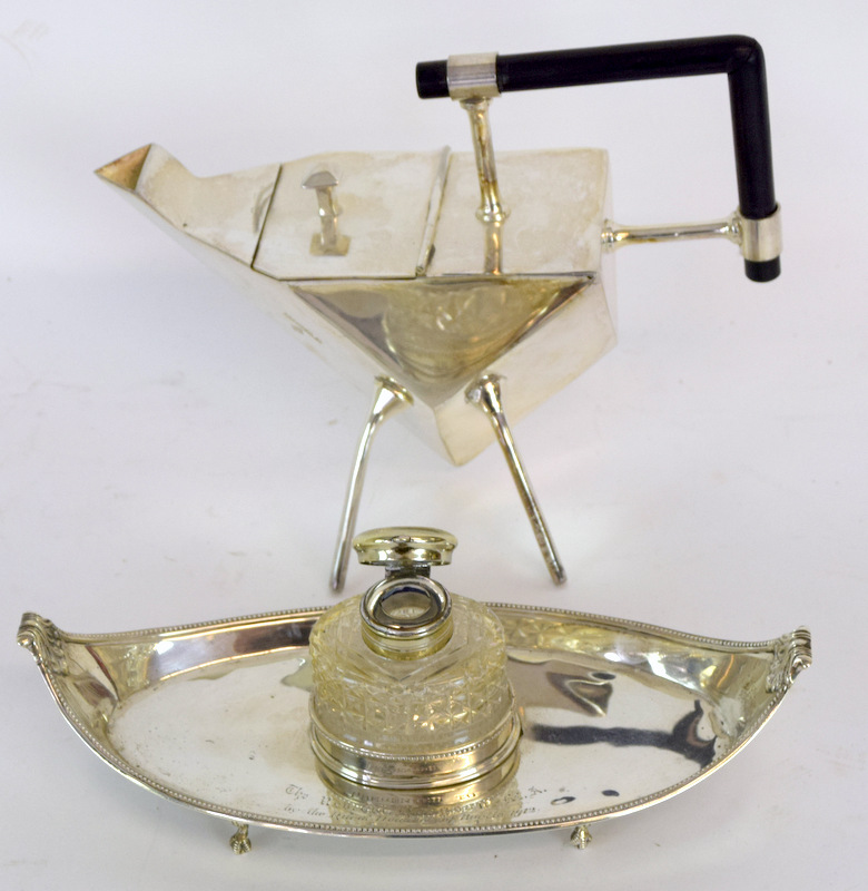 A Silver Oval Shaped Desk Stand Standing On Ball And Claw Feet