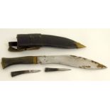 A military issue Gorkha Army kukri in its leather scabbard complete with its two sharpening