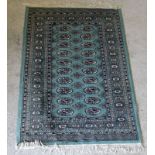 Green Turkish rug with blue surround. 155 x 95cm