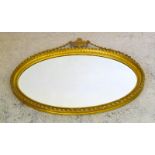 A Gilt overmantle mirror with swag decoration. 85 x 100