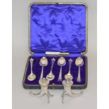 Pair of silver horn shaped salt & peppers and a set of boxed teaspoons