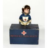 An early 20th century British Red Cross Society wooden collection box with a nurse figure. 18cms