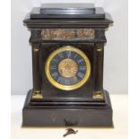 Slate mantle clock with bronze surround, with key. 40cm tall