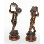 A pair of bronze winged cherubs. 32cm high