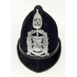 An obsolete Hampshire Police helmet with badge. Retains its chin strap but no liner