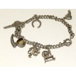 Silver ladies charm bracelet together with 7 charms