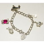 Silver charm bracelet and 5 charms weight 30gm