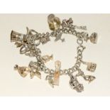 Silver ladies charm bracelet together with 20 charms