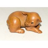 Wooden Japanese Netsuke in the form of a pig. Signed to the underside