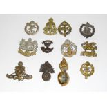 Twelve Army cap badges including a Highland Light Infantry officers silver and brass badge