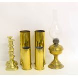 Collection of brass to include shell cases. oil lamp and candlesticks