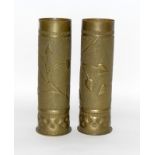 An impressive matching pair of WW1 trench art shell case vases decorated with foliage. 27.5cms by