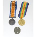 A WW1 medal pair with his dog tag named to 147280 Gunner AE Boon of the Royal Artillery