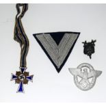 A Third Reich Mothers Cross with three other German badges