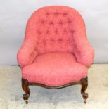 Victorian button back nursing chair on carved legs with porcelain casters