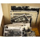 Box containing early black and white postcards, photographs to include Coronation programmes