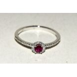 18ct white gold ruby and diamond cluster ring of approx 40 points. Size M