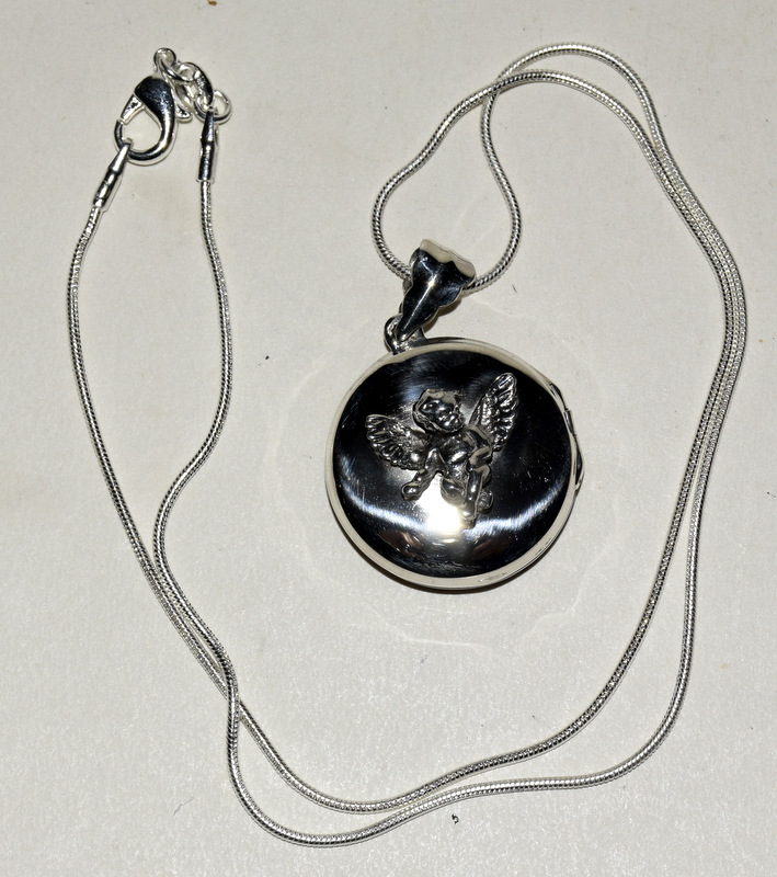 Silver locket with winged fairy to the lid