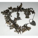 Silver charm bracelet together with 33 charms 92g