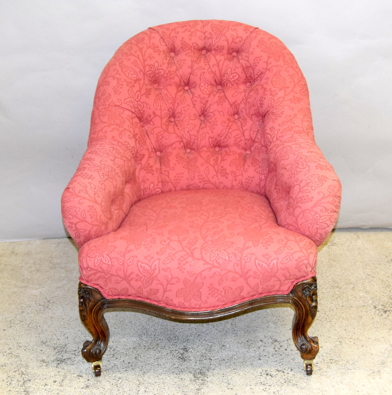 Victorian button back nursing chair on carved legs with porcelain casters