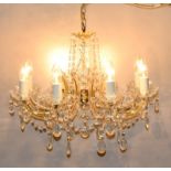 Ornate 8 branch chandelier with scroll arms and tear shaped lustre drops