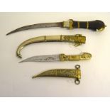 Two Syrian Jambiya daggers in their scabbards. Blade lengths 23cms and 15cms