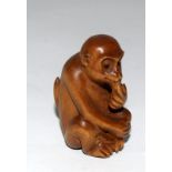 Wooden Japanese Netsuke in the form of a monkey signed to the base