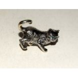 Heavy cast silver figure of a cat with emerald eyes