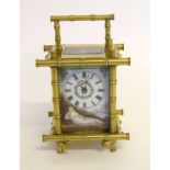 Bamboo framed carriage clock with decorative panels. with key