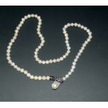 freshwater pearl necklace with a Baroque pearl clasp in the form of a snake inset with sapphires and