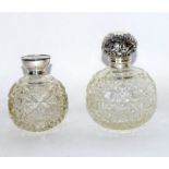 Two silver topped perfume bottles