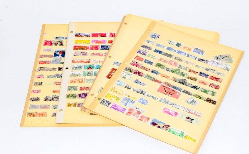 Large collection of world stamps on vintage album sheets