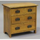An Edwardian satin walnut chest of three long drawers with cast metal handle plates, on bracket