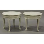 A pair of 20th century French white painted circular occasional tables, raised on cabriole legs,