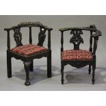 Two late Victorian carved oak corner armchairs, decorated with griffons' masks and foliate sprays,