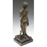 After Michelangelo - a modern cast bronze figure of Bacchus standing beside a seated fawn, the