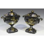 A pair of 19th century Pontypool tole painted urns and covers, decorated in gilt on a black