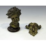 A late 19th century French gilt patinated cast bronze bust of an infant's head, raised on a turned