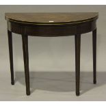 A George III mahogany fold-over demi-lune card table, the hinged top crossbanded in rosewood above a