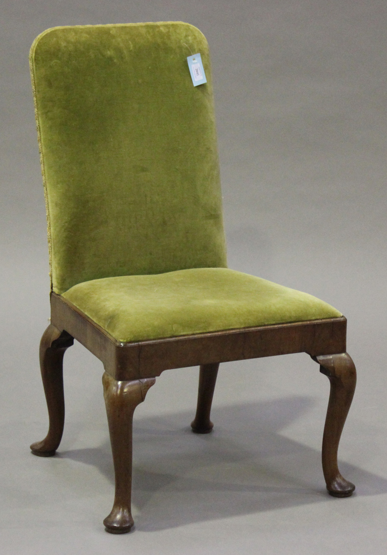 A Queen Anne walnut side chair, the upholstered seat and back above a deep seat rail, raised on