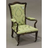 A Regency rosewood showframe library armchair, upholstered in a patterned light green damask, raised