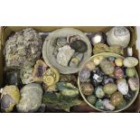 A collection of various mineral specimens, including a group of carved eggs, two bowls and a section